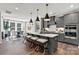 Modern kitchen with granite island, pendant lights, and stainless steel appliances at 162 Nicholson Ln, Mooresville, NC 28115