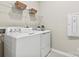 Well-lit laundry room featuring white washer and dryer, with convenient shelving at 162 Nicholson Ln, Mooresville, NC 28115