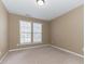 Neutral bedroom with carpet, two windows with blinds, and tan walls at 165 N Arcadian Way, Mooresville, NC 28117