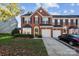 Charming two-story brick home with a two-car garage and manicured front lawn at 165 N Arcadian Way, Mooresville, NC 28117