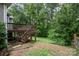 A multi-tiered back deck and lush, green backyard offer a serene retreat at 17318 Cambridge Grove Dr, Huntersville, NC 28078