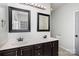 Bright bathroom boasts double sinks, dark cabinets, a large mirror, and modern fixtures at 17318 Cambridge Grove Dr, Huntersville, NC 28078