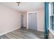 Bedroom with hardwood floors, window with curtains, and a closet with gray doors at 17318 Cambridge Grove Dr, Huntersville, NC 28078