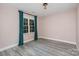 Airy bedroom features hardwood floors, window with curtains, and neutral walls at 17318 Cambridge Grove Dr, Huntersville, NC 28078