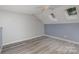 Bedroom with skylights, hardwood floors, and neutral-colored walls at 17318 Cambridge Grove Dr, Huntersville, NC 28078