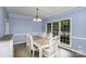 Formal dining room features wainscoting, chandelier, and a large window at 17318 Cambridge Grove Dr, Huntersville, NC 28078