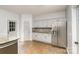 Renovated kitchen features stainless steel appliances, granite counters, mosaic backsplash, and gray cabinets at 17318 Cambridge Grove Dr, Huntersville, NC 28078