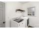 Bright laundry room with white appliances, a shelf, and a window providing natural light at 17318 Cambridge Grove Dr, Huntersville, NC 28078