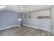 Open living area featuring hardwood floors, a modern ceiling fan, and neutral-colored walls at 17318 Cambridge Grove Dr, Huntersville, NC 28078