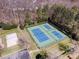 Aerial shot of community tennis and volleyball courts surrounded by mature trees at 17318 Cambridge Grove Dr, Huntersville, NC 28078