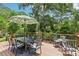 Outdoor dining set on back deck surrounded by natural green trees at 1737 Hwy 109 N Hwy, Troy, NC 27371