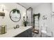 Modern bathroom with stylish fixtures, a round mirror, and sleek design at 1737 Hwy 109 N Hwy, Troy, NC 27371