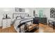 Stylish bedroom with hardwood floors, a metal frame bed, and neutral decor at 1737 Hwy 109 N Hwy, Troy, NC 27371
