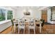 Bright dining room with white walls, wood floors, a chandelier, and a large window with natural light at 1737 Hwy 109 N Hwy, Troy, NC 27371