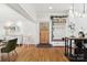 Bright foyer with hardwood floors, shiplap accents, decorative shelving, and easy access to the kitchen at 1737 Hwy 109 N Hwy, Troy, NC 27371