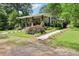 Inviting home with a covered front porch, stone pillar accents, and meticulously landscaped front yard at 1737 Hwy 109 N Hwy, Troy, NC 27371