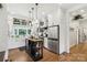 Spacious kitchen featuring stainless steel refrigerator, butcher block island and white cabinetry at 1737 Hwy 109 N Hwy, Troy, NC 27371