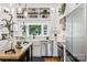 Kitchen featuring stainless steel appliances, white cabinets, countertops and farmhouse style sink at 1737 Hwy 109 N Hwy, Troy, NC 27371