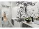 Stylish laundry room featuring modern appliances, a dark floral mural and bright white trim at 1737 Hwy 109 N Hwy, Troy, NC 27371