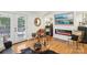 Comfortable living room featuring hardwood floors, fireplace, and access to outdoor deck at 1737 Hwy 109 N Hwy, Troy, NC 27371