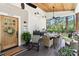 Inviting outdoor dining space on a covered porch, complete with comfortable seating and decorative lighting at 1737 Hwy 109 N Hwy, Troy, NC 27371
