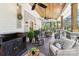 Spacious covered porch with comfortable seating, dining area, ceiling fans, and wooded views at 1737 Hwy 109 N Hwy, Troy, NC 27371