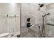 Shower with gray tiling, black hardware, and hand-held sprayer at 1737 Hwy 109 N Hwy, Troy, NC 27371