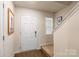 Entryway with a white door, hardwood floors, and staircase with neutral paint at 2009 Talbert Ct, Charlotte, NC 28214