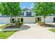 Exterior view of a townhouse with a driveway and lawn and large trees in front of each unit at 2009 Talbert Ct, Charlotte, NC 28214