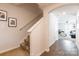 Hallway with staircase leading to the living room featuring hardwood floors and neutral paint at 2009 Talbert Ct, Charlotte, NC 28214