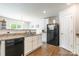 Kitchen showcasing granite counters, white cabinets, black appliances, and hardwood flooring at 2009 Talbert Ct, Charlotte, NC 28214