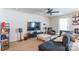Living room featuring a ceiling fan, large television, and comfortable seating at 2009 Talbert Ct, Charlotte, NC 28214