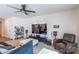 Living room with a large television, ceiling fan, and neutral carpet flooring at 2009 Talbert Ct, Charlotte, NC 28214