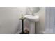 Small powder room with pedestal sink and simple decor at 2009 Talbert Ct, Charlotte, NC 28214