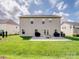 Back exterior of a two-story home with sliding glass door leading to the patio and backyard at 2178 Stone Pile Sw Dr, Concord, NC 28025