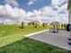 Well-maintained backyard features a concrete patio and lush, green lawn at 2178 Stone Pile Sw Dr, Concord, NC 28025