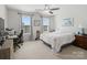 Comfortable bedroom with a bed, desk, and bright natural light from two windows at 2178 Stone Pile Sw Dr, Concord, NC 28025