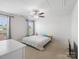 Bright bedroom featuring a ceiling fan and a large window with great natural light at 2178 Stone Pile Sw Dr, Concord, NC 28025