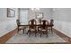 Formal dining room showcasing a large wooden table, elegant chairs, wainscoting, and a decorative mirror at 2178 Stone Pile Sw Dr, Concord, NC 28025