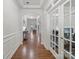 Spacious hallway featuring hardwood floors, decorative trim, arched doorways, and access to multiple rooms at 2178 Stone Pile Sw Dr, Concord, NC 28025