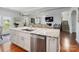 Kitchen island with stainless dishwasher and open views to the living room at 2178 Stone Pile Sw Dr, Concord, NC 28025