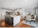 Modern kitchen includes white cabinetry, granite countertops, and stainless appliances at 2178 Stone Pile Sw Dr, Concord, NC 28025