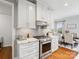 Close up of a modern kitchen with white cabinetry and stainless steel appliances at 2178 Stone Pile Sw Dr, Concord, NC 28025