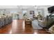 Open-concept living room featuring hardwood floors, natural light, comfortable seating, and access to the backyard at 2178 Stone Pile Sw Dr, Concord, NC 28025