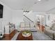 Open living room featuring hardwood flooring and an arched entry way at 2178 Stone Pile Sw Dr, Concord, NC 28025