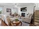Comfortable living room featuring a fireplace, large TV, and plush leather seating at 2178 Stone Pile Sw Dr, Concord, NC 28025