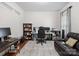 Well-lit office with hardwood floors, a comfortable leather couch, and a functional workspace with multiple monitors at 2178 Stone Pile Sw Dr, Concord, NC 28025