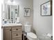 Stylish half-bathroom with a vanity, framed artwork, and neutral colors that create a fresh and clean look at 2178 Stone Pile Sw Dr, Concord, NC 28025