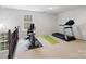 Bright workout area with exercise bike and treadmill at 2178 Stone Pile Sw Dr, Concord, NC 28025