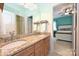 Bathroom boasts double sinks with granite countertops, wood cabinets, and a view into the bedroom at 2300 Lord Anson Dr, Waxhaw, NC 28173